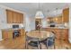 Open kitchen with wooden cabinets, granite countertops, and a casual dining area at 1237 Shirehall Park Ln, Wake Forest, NC 27587