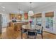 Bright kitchen with wooden cabinets, stainless steel appliances, and a center island with granite countertops at 1237 Shirehall Park Ln, Wake Forest, NC 27587