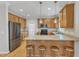 Spacious kitchen featuring wood cabinets, granite countertops, stainless steel appliances, and bar seating at 1237 Shirehall Park Ln, Wake Forest, NC 27587