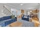 Spacious living room with hardwood floors, comfortable blue seating, and an open layout at 1237 Shirehall Park Ln, Wake Forest, NC 27587