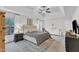 Spacious primary bedroom with a tray ceiling, large windows, and stylish decor, offering a luxurious retreat at 1237 Shirehall Park Ln, Wake Forest, NC 27587