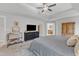 Well-lit main bedroom featuring a tray ceiling, a dark dresser, and a connected bathroom, creating a convenient retreat at 1237 Shirehall Park Ln, Wake Forest, NC 27587