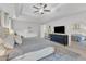 Serene main bedroom with a tray ceiling, a ceiling fan, and ample space, creating a relaxing and inviting atmosphere at 1237 Shirehall Park Ln, Wake Forest, NC 27587