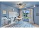 Bright playroom with blue walls, ceiling fan, learning materials, and window that provides natural light at 1237 Shirehall Park Ln, Wake Forest, NC 27587