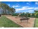 Community playground featuring a slide, swings, and benches for residents' enjoyment at 1237 Shirehall Park Ln, Wake Forest, NC 27587