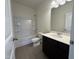 Modern bathroom with a sleek vanity, a soaking tub, and tiled flooring at 128 Bruce Dr, Dunn, NC 28334