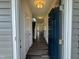 Inviting entryway featuring wood-look floors, a view of the stairs, and a stylish blue front door at 128 Bruce Dr, Dunn, NC 28334