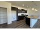 Modern kitchen with dark cabinets, granite countertops, stainless steel appliances and an island at 128 Bruce Dr, Dunn, NC 28334