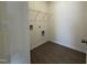 Functional laundry room with tile floors, wire shelving, and washer/dryer hookups at 128 Bruce Dr, Dunn, NC 28334