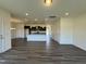 Spacious open-concept living room with wood-look floors flowing into the kitchen area at 128 Bruce Dr, Dunn, NC 28334