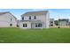 A new construction home featuring a backyard with grass and a covered porch at 140 Benson Village Dr # 83, Benson, NC 27504