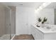 Bathroom with double sink vanity, quartz counters, and a glass-enclosed shower at 140 Benson Village Dr # 83, Benson, NC 27504