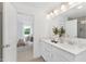 Bright bathroom featuring a double vanity, framed mirrors, and views into the main bedroom at 140 Benson Village Dr # 83, Benson, NC 27504