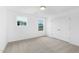 Bedroom with carpet, white walls, natural light from two windows, and a double door closet at 140 Benson Village Dr # 83, Benson, NC 27504