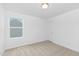 Well-lit bedroom with neutral walls, carpet flooring, and a large window for natural light at 140 Benson Village Dr # 83, Benson, NC 27504