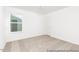 Bedroom featuring neutral carpet, a window offering natural light, and a door at 140 Benson Village Dr # 83, Benson, NC 27504