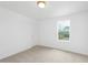 Bright bedroom with carpet flooring, neutral walls, window with outside views, and standard door at 140 Benson Village Dr # 83, Benson, NC 27504