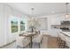 Elegant dining room featuring a modern chandelier, a stylish dining table, and large windows with bright natural light at 140 Benson Village Dr # 83, Benson, NC 27504