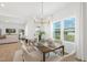 Inviting dining room featuring a modern chandelier, a stylish dining table, and large windows with views of the backyard at 140 Benson Village Dr # 83, Benson, NC 27504