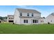 New construction, two-story home featuring white siding, gray roof, a covered porch, and a spacious, well-maintained lawn at 140 Benson Village Dr # 83, Benson, NC 27504