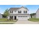 Beautiful two-story home featuring white siding, black shutters, a two-car garage, and a well-maintained front lawn at 140 Benson Village Dr # 83, Benson, NC 27504