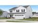 Charming two-story home boasts white siding, black shutters, a two-car garage, and a nicely landscaped lawn at 140 Benson Village Dr # 83, Benson, NC 27504