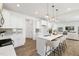 Modern kitchen featuring white cabinets, stainless steel appliances, a quartz countertop island, and pendant lighting at 140 Benson Village Dr # 83, Benson, NC 27504