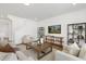 An open living room with decorative shelving, neutral furniture, and an area rug at 140 Benson Village Dr # 83, Benson, NC 27504
