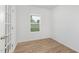 Office space featuring wood-look floors, white walls, and natural light through a window at 140 Benson Village Dr # 83, Benson, NC 27504