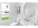 Modern powder room featuring a round mirror, pedestal sink, and natural light at 140 Benson Village Dr # 83, Benson, NC 27504
