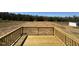 Large wooden outdoor back deck overlooking large backyard with treeline in back at 140 Brookhaven Dr, Spring Hope, NC 27882