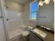 Bright bathroom featuring a shower with a built-in seat and a vanity with a modern sink and stylish fixtures at 140 Brookhaven Dr, Spring Hope, NC 27882