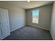 Bedroom featuring neutral carpeting, with a bright window and a clean aesthetic that emphasizes simplicity and comfort at 140 Brookhaven Dr, Spring Hope, NC 27882