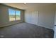 Bedroom with plush carpet, neutral paint, and a large window overlooking the backyard at 140 Brookhaven Dr, Spring Hope, NC 27882