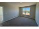 Bedroom with neutral walls and plush carpeting complemented by a bright window that enhances the serene atmosphere at 140 Brookhaven Dr, Spring Hope, NC 27882
