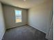 Bedroom featuring neutral walls, plush carpeting, and a large window that brightens the space with natural light at 140 Brookhaven Dr, Spring Hope, NC 27882