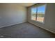 Cozy bedroom with neutral carpeting, walls, and a large window that adds warmth and natural light to the room at 140 Brookhaven Dr, Spring Hope, NC 27882