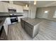 Bright kitchen featuring stainless appliances, gray countertop island, and hardwood floors at 140 Brookhaven Dr, Spring Hope, NC 27882