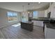 Bright kitchen featuring stainless appliances, gray countertop island, and hardwood floors at 140 Brookhaven Dr, Spring Hope, NC 27882