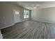 Open-concept living room with spacious layout, neutral paint and luxury vinyl plank flooring at 140 Brookhaven Dr, Spring Hope, NC 27882
