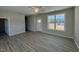 Open-concept living room with spacious layout, neutral paint and luxury vinyl plank flooring at 140 Brookhaven Dr, Spring Hope, NC 27882