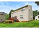 Green backyard with wooden deck, well-manicured lawn and mature trees, creates an ideal outdoor living space at 1405 Merrilow Ct, Wake Forest, NC 27587