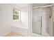 Bathroom showcasing soaking tub, walk in shower, and window to the outside at 1405 Merrilow Ct, Wake Forest, NC 27587