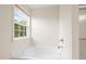 Bathroom showing a soaking tub and window with a view to the exterior at 1405 Merrilow Ct, Wake Forest, NC 27587