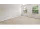 Bright bedroom featuring neutral carpet, white walls, and two windows offering natural light at 1405 Merrilow Ct, Wake Forest, NC 27587