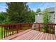 Spacious wooden deck features a stained railing and serene backyard views at 1405 Merrilow Ct, Wake Forest, NC 27587