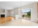 Bright dining area featuring a chandelier, sliding doors to a deck, and adjacent to a living room with a fireplace at 1405 Merrilow Ct, Wake Forest, NC 27587