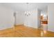 Spacious dining area with hardwood floors, a modern chandelier, and an open connection to the kitchen, perfect for Gathering gatherings at 1405 Merrilow Ct, Wake Forest, NC 27587