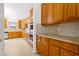 Well-equipped kitchen with wood cabinets, stainless steel appliances, and ample counter space for meal preparation and casual dining at 1405 Merrilow Ct, Wake Forest, NC 27587