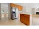 Open-concept kitchen with stainless steel refrigerator and a central island, providing ample space for cooking and entertaining guests at 1405 Merrilow Ct, Wake Forest, NC 27587
